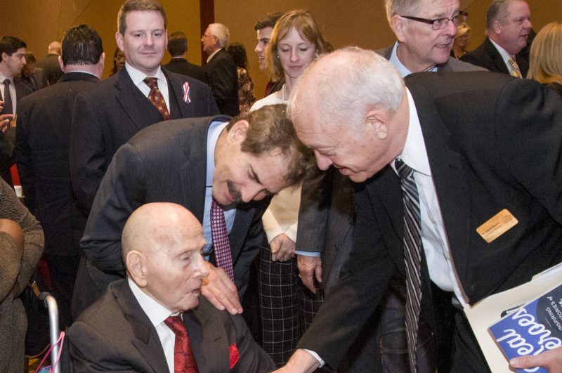 Dr. Michael H. Mescon, (seated, left) the recipient of the Foundation's prestigious Freedom Award, is congratulated by keynote speaker John Stossel (center) of Fox Business Network and Dr. David Martin, who presented the Freedom Award at the Foundation's 25th anniversary celebration on November 11.
